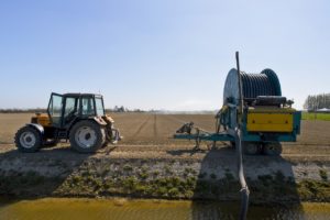 Irrigation tractor with water pump and hose reel